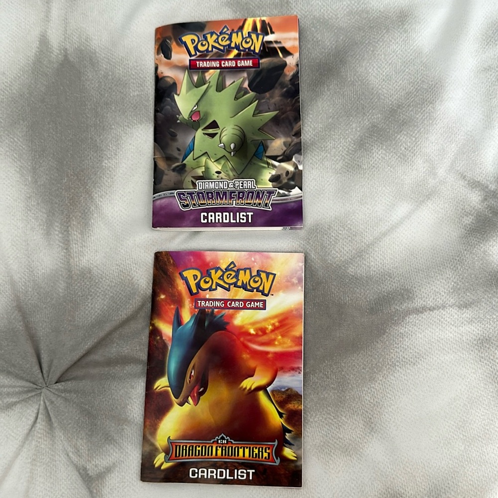 Pokémon card list books. Rulebook on back. Dragon frontier and Stormfront